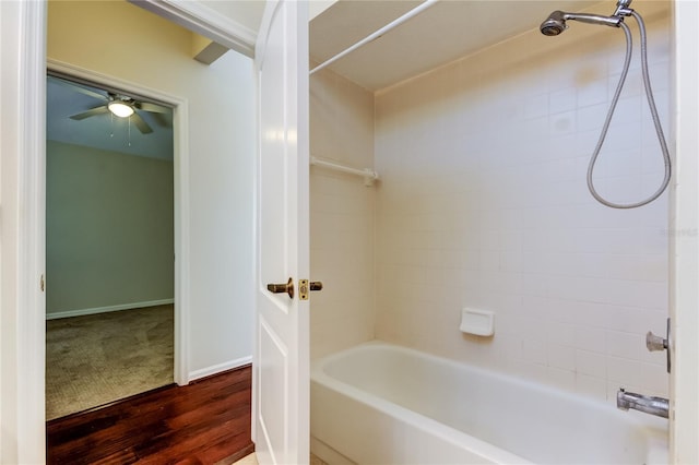 bathroom with ceiling fan, tiled shower / bath, and hardwood / wood-style floors