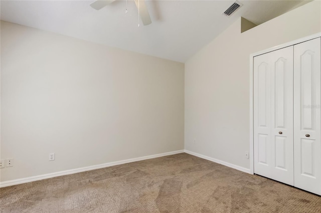 unfurnished bedroom featuring light colored carpet, a closet, and ceiling fan