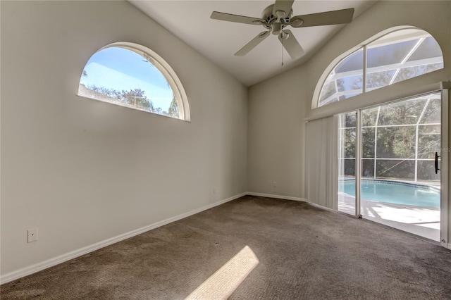 spare room with vaulted ceiling, carpet flooring, and ceiling fan