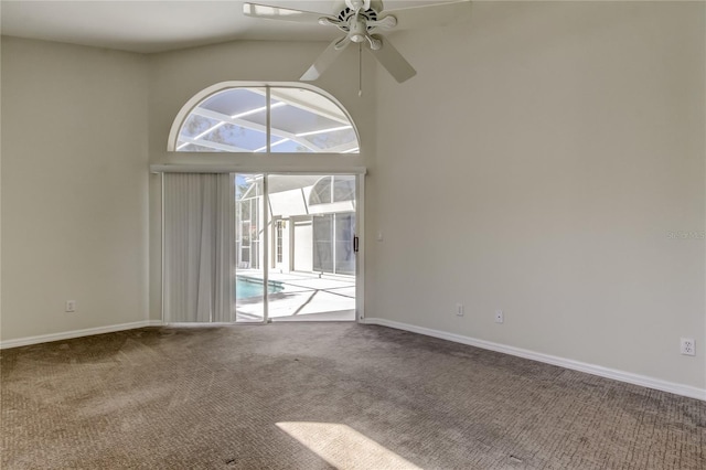 carpeted empty room featuring ceiling fan and high vaulted ceiling