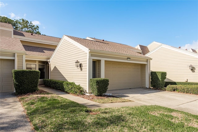 view of side of home with driveway and a shingled roof