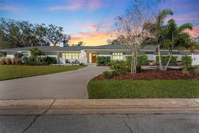 ranch-style home featuring a yard