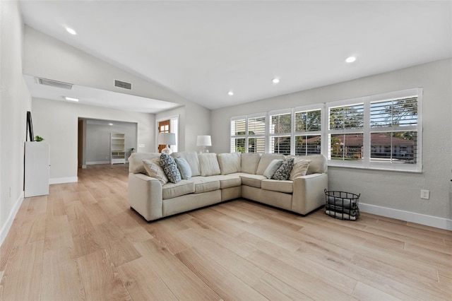 living room with lofted ceiling and light hardwood / wood-style flooring