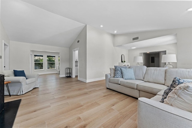 living room with high vaulted ceiling and light hardwood / wood-style floors