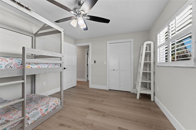 unfurnished bedroom with ceiling fan and light hardwood / wood-style floors