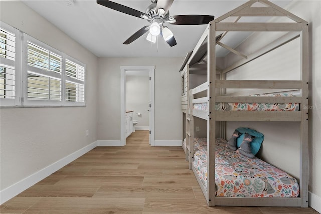 bedroom with light wood-type flooring, connected bathroom, and ceiling fan