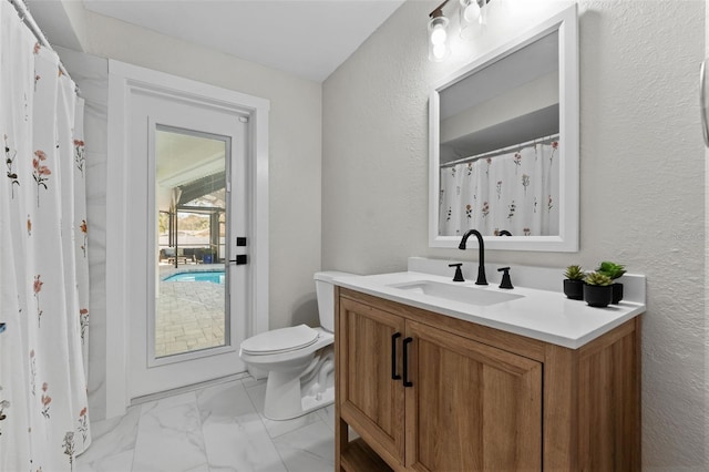 bathroom featuring toilet and vanity