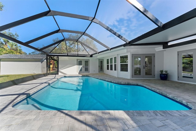 view of pool featuring a patio, a lanai, and french doors