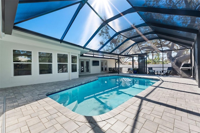 view of swimming pool with a patio area, french doors, and glass enclosure