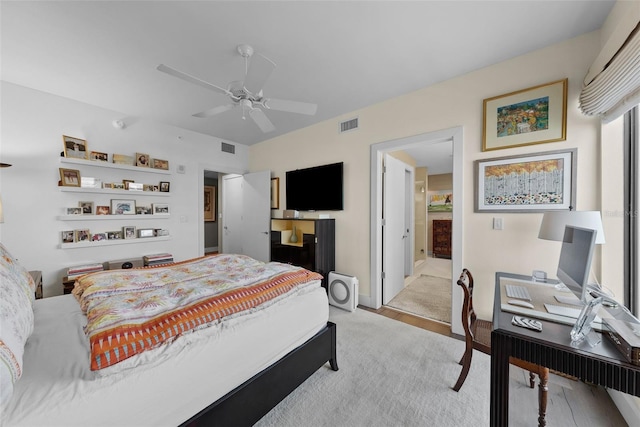 bedroom with ensuite bathroom and ceiling fan