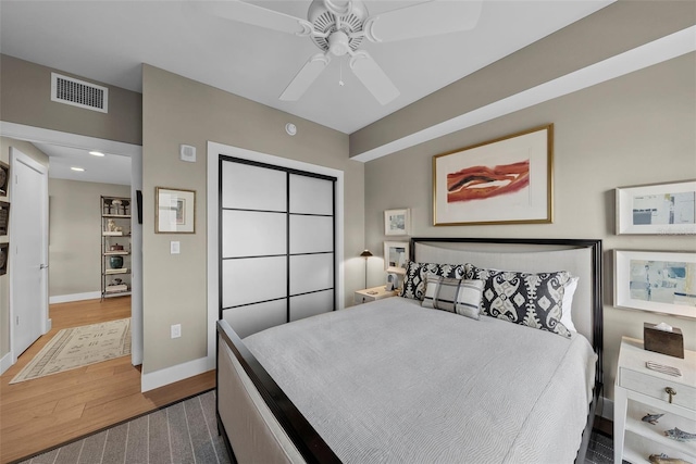 bedroom with ceiling fan and dark hardwood / wood-style flooring