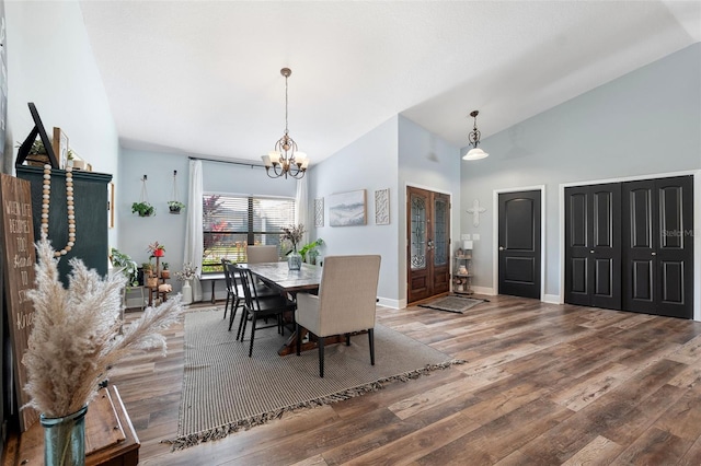 dining area featuring high vaulted ceiling, hardwood / wood-style floors, and a notable chandelier