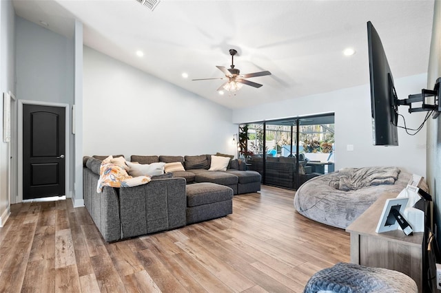 living room with lofted ceiling, hardwood / wood-style floors, and ceiling fan