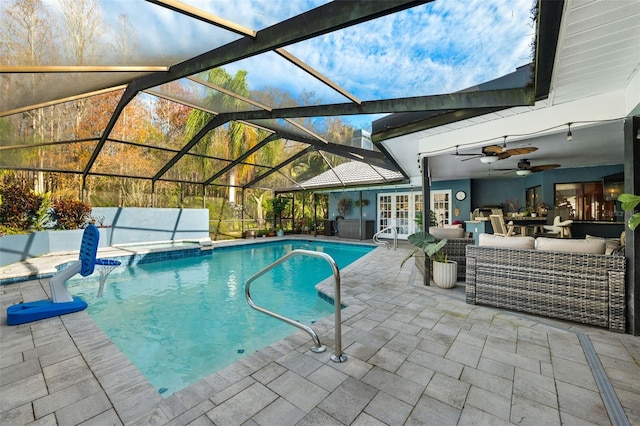 view of pool with french doors, glass enclosure, ceiling fan, an outdoor hangout area, and a patio