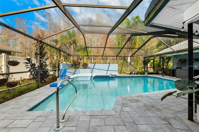 view of swimming pool with a lanai and a patio area