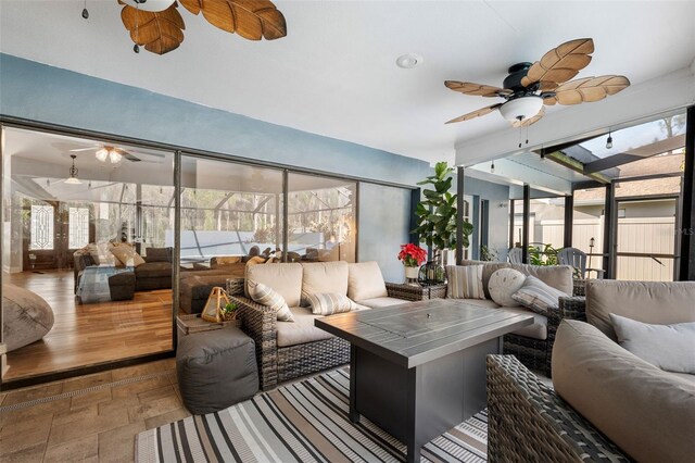 sunroom featuring ceiling fan