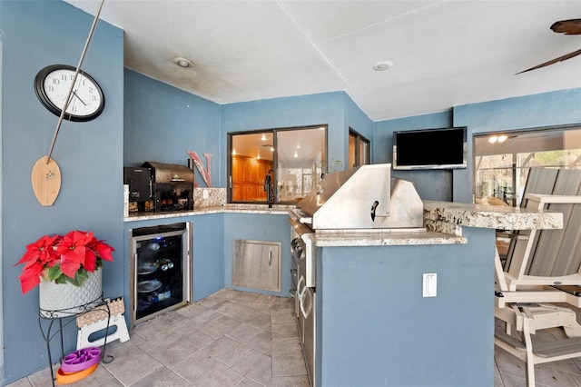 kitchen with wine cooler, kitchen peninsula, and sink