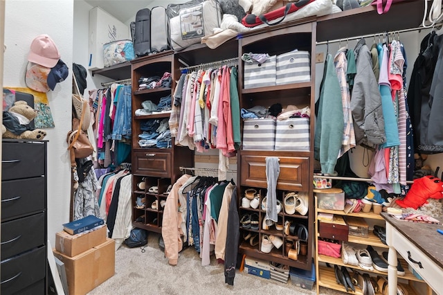 walk in closet with carpet floors