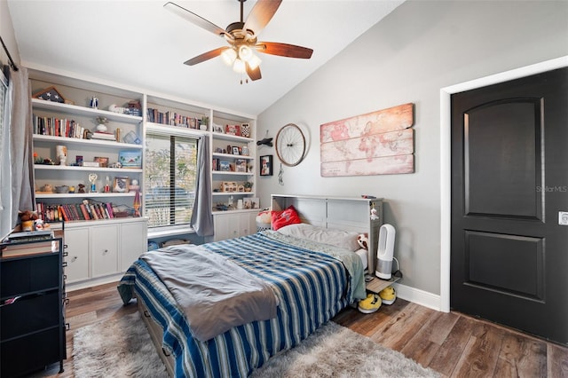 bedroom with lofted ceiling, dark hardwood / wood-style floors, and ceiling fan