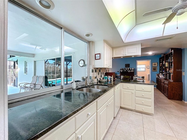 kitchen featuring visible vents, white cabinetry, a sink, and light tile patterned flooring