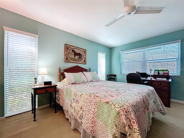 bedroom featuring baseboards, ceiling fan, and light carpet