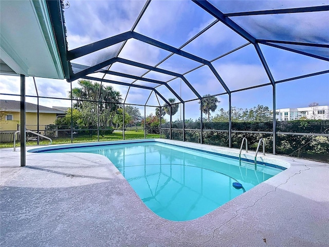 pool featuring glass enclosure and a patio