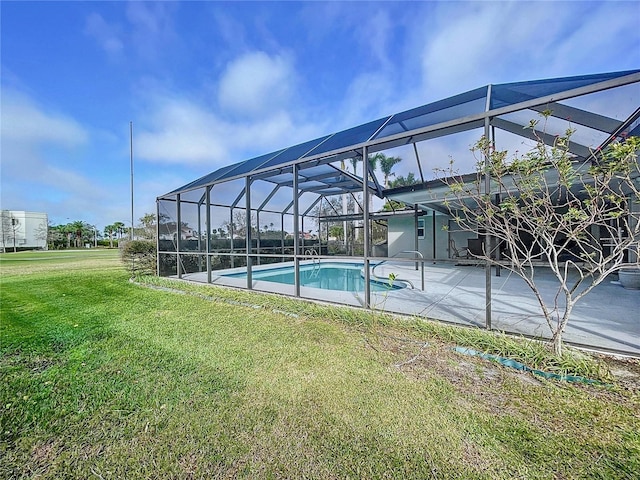 pool with a patio, a yard, and glass enclosure