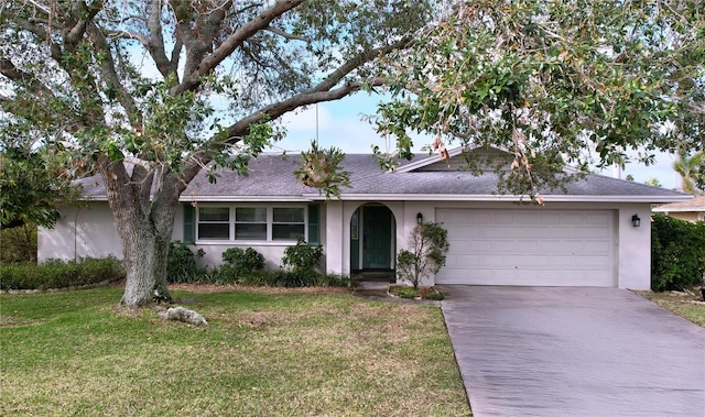 single story home with stucco siding, driveway, an attached garage, and a front yard