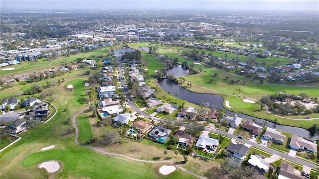 aerial view with a residential view, view of golf course, and a water view