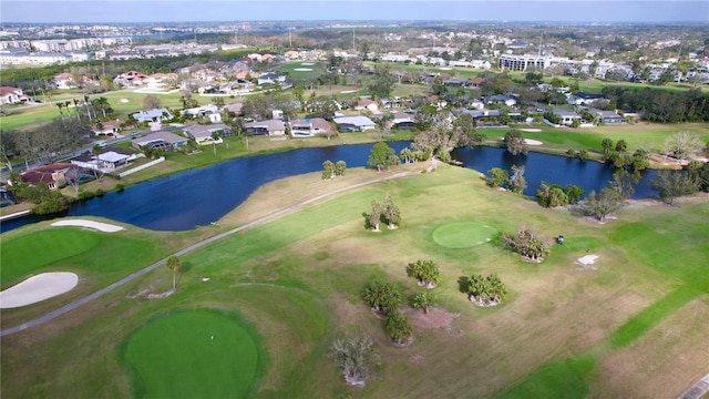 drone / aerial view with a residential view, view of golf course, and a water view