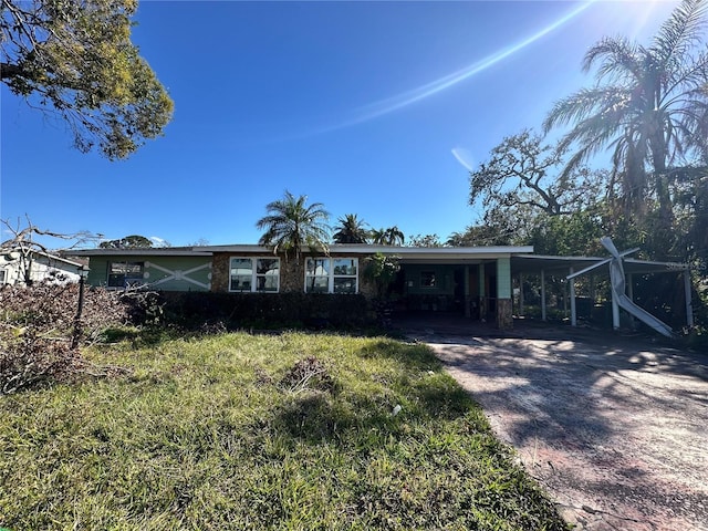 single story home with driveway and an attached carport