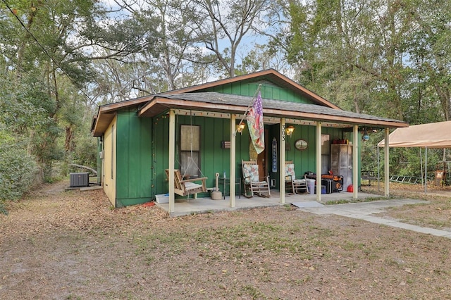 view of front of home with central air condition unit and an outdoor structure