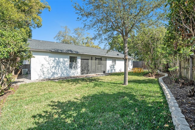 rear view of property featuring a lawn