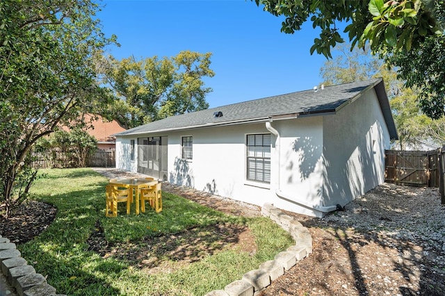 back of house featuring a lawn