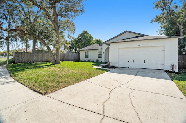 single story home featuring a garage and a front lawn