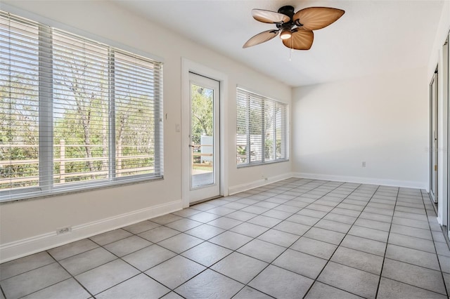 spare room featuring baseboards and a ceiling fan