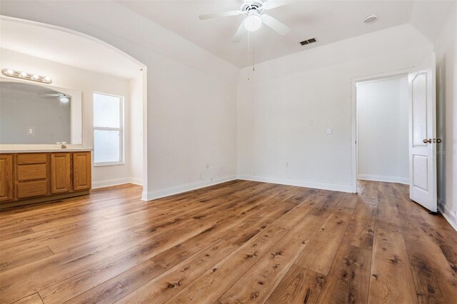 unfurnished bedroom featuring baseboards, visible vents, and light wood finished floors