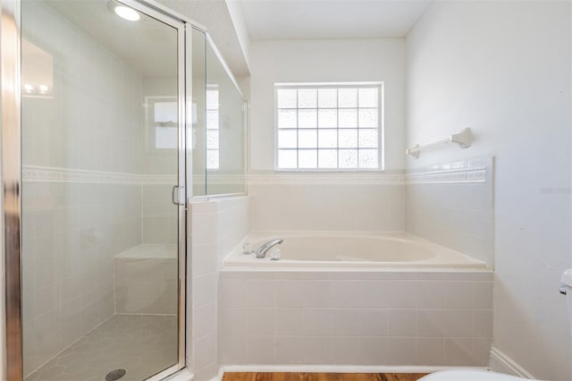 bathroom featuring a garden tub and a stall shower