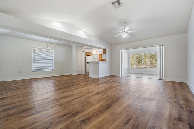 unfurnished living room featuring dark wood-style floors, visible vents, vaulted ceiling, ceiling fan, and baseboards