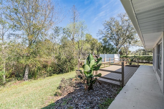 view of yard featuring a deck and fence