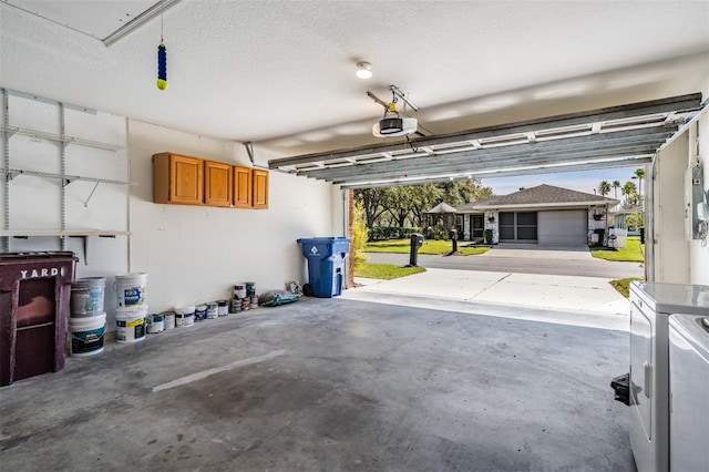 garage featuring a garage door opener and separate washer and dryer