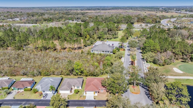 drone / aerial view with a residential view and a view of trees