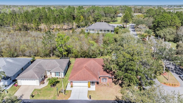 drone / aerial view featuring a forest view