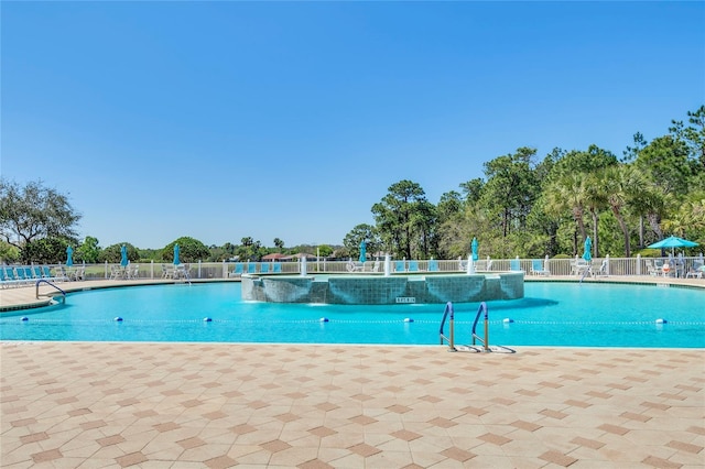 community pool featuring a patio area and fence