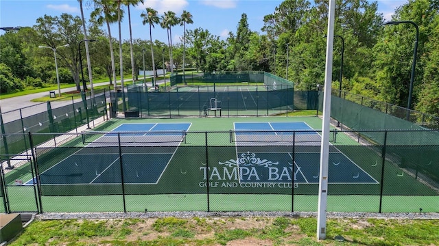 view of sport court featuring fence