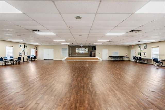 miscellaneous room with baseboards, visible vents, and wood finished floors