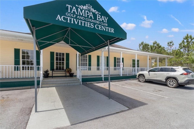 view of building exterior featuring uncovered parking