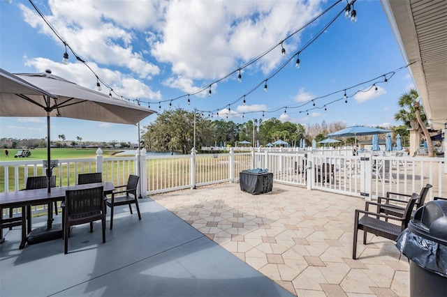 view of patio featuring outdoor dining space, area for grilling, and fence