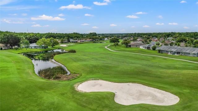 view of community with view of golf course and a water view