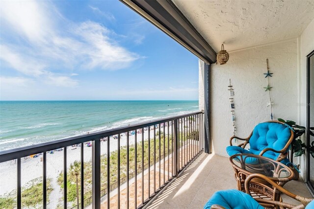 balcony with a view of the beach and a water view